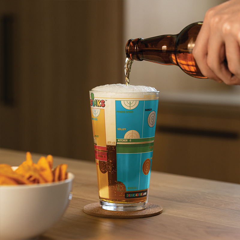 Drinks4Dinks pint glass printed with a pickleball drinking game design